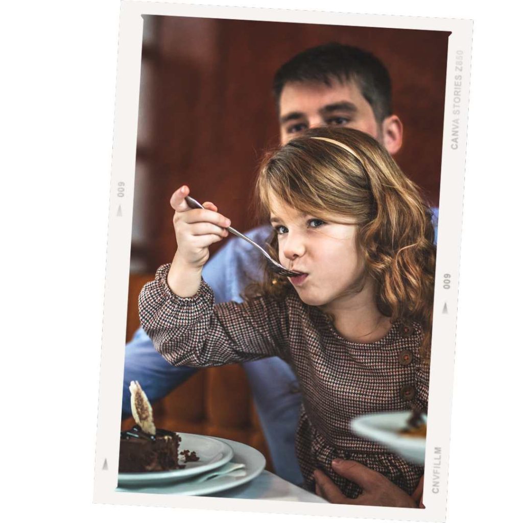 father and daughter eating at a restaurant