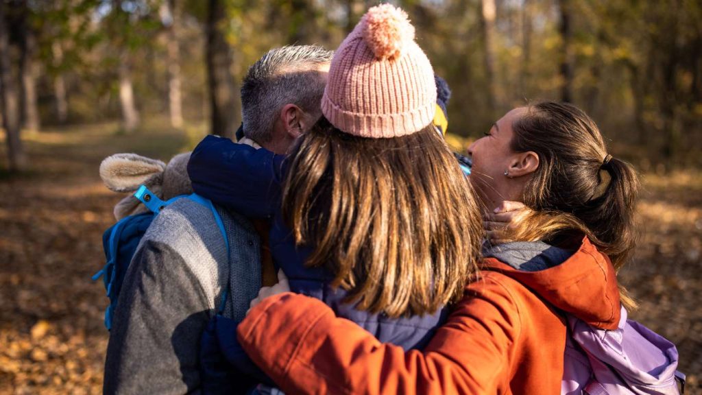 family hugging, navigating challanges together