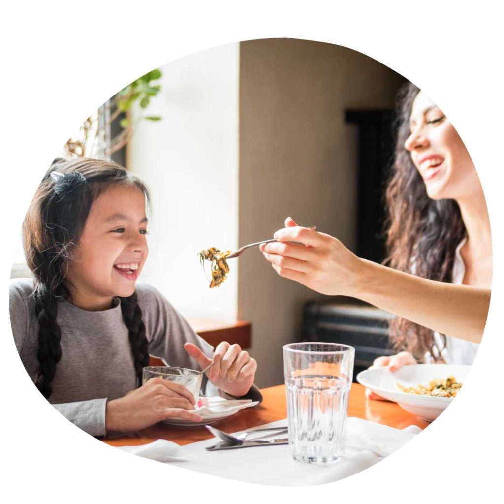 mother and daughter eating at a restaurant